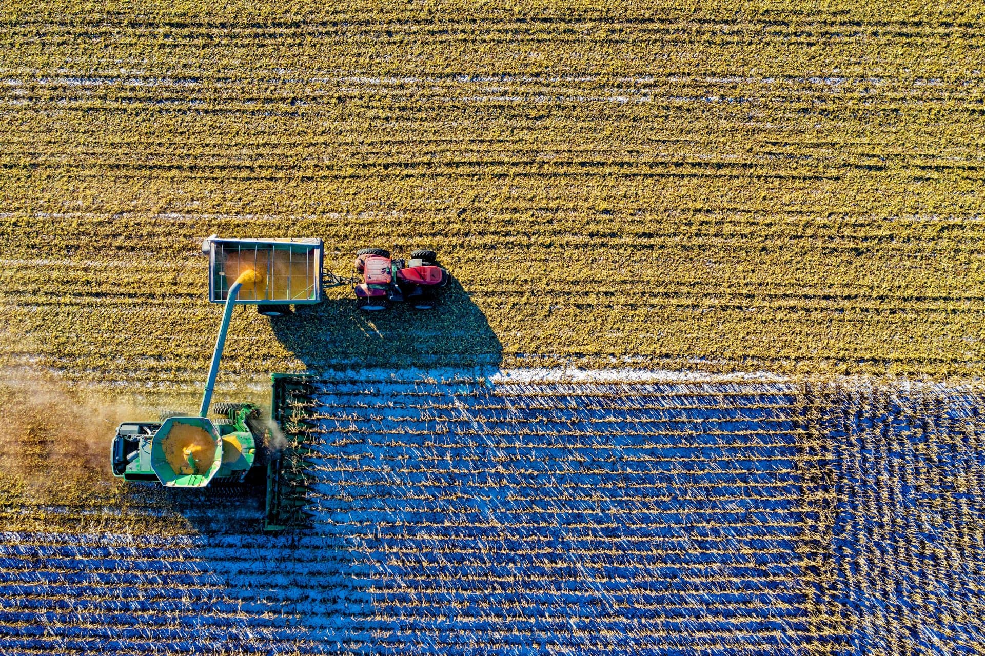 Aerial view of a combine harvester working a crop field
