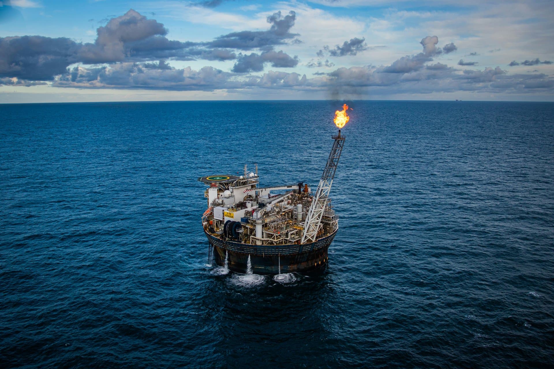 Offshore oil production platform with a gas flare at sea